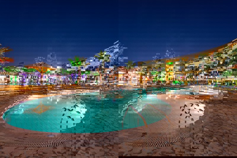 Night view of pool at Caretta beach holiday village